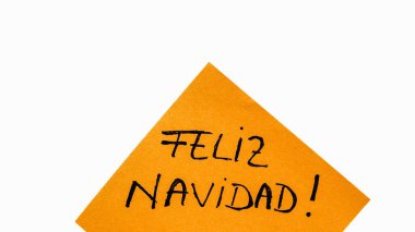 Feliz Navidad (Mutlu Noeller) el yazısı, fotokopi alanı olan turuncu kağıda izole edilmiş. Anımsatıcı üzerine metin yazılıyor.