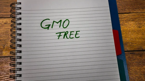 GMO Genetically modified organism free handwriting  text on paper, on office agenda. Copy space.