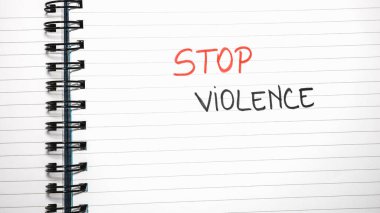 Stop violence handwriting  text on paper, on office agenda. Copy space.