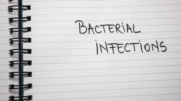 Bacterial infections handwriting  text on paper, on office agenda. Copy space.