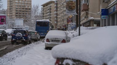 Romanya 'nın Bükreş kentinde kışın ilk günü, karla kaplı arabalar