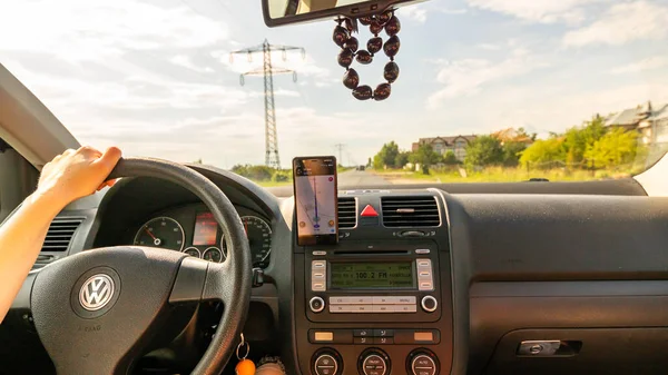 stock image Smartphone showing Waze maps to show the way thru the city. Driver using Waze maps