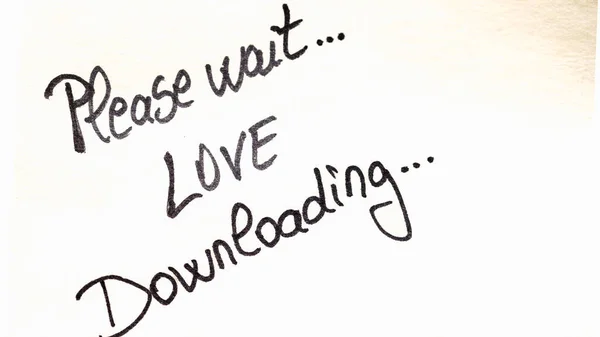 Please wait love downloading handwriting text close up isolated on yellow paper with copy space.