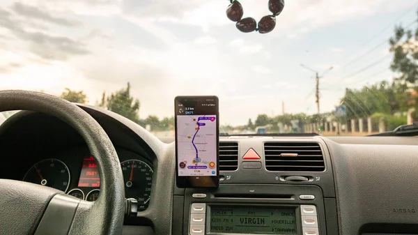 stock image Smartphone showing Waze maps to show the way thru the city. Driver using Waze maps