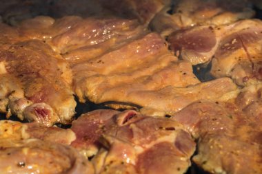 Kömür mangalında çiğ biftek. Kamp manzarası, lezzetli barbekü, yemek konsepti, ızgaradaki yemek ve ızgaradaki yemeğin ayrıntıları.