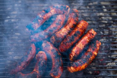 Kömür mangalında ızgara domuz eti ve sosis. Lezzetli barbekü, yemek konsepti, ızgaradaki yemek ve ızgaradaki yemeğin ayrıntıları.