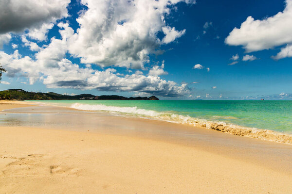 Caribbean beach with white sand, deep blue sky and turquoise water