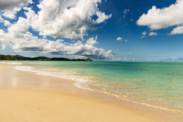 Caribbean beach with white sand, deep blue sky and turquoise water