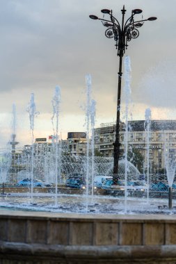 Fountain at Unirii Square in downtown of Bucharest.  Unirii Boulevard in Bucharest, Romania, 2021 clipart