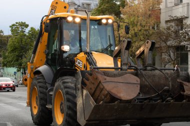 Construction workers at construction site and heavy duty bulldozer in Bucharest, Romania, 2023