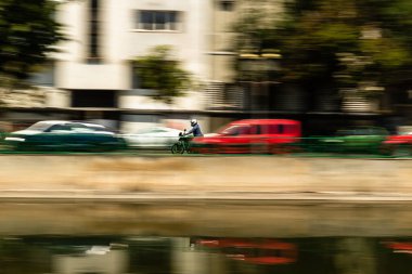 Biker on a motorcycle in traffic at rush hour in downtown area of the city in Bucharest, Romania, 2022