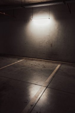 Boş yer altı garajı. Boş park yeri ve loş ışık
