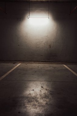 Boş yer altı garajı. Boş park yeri ve loş ışık