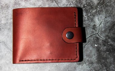 Close-up of a handmade leather wallet, classic brown. Leather craft.