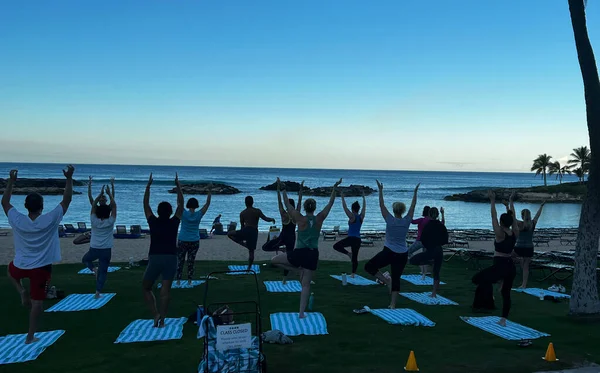 Morning yoga class at the beach at a resort in Hawaii.