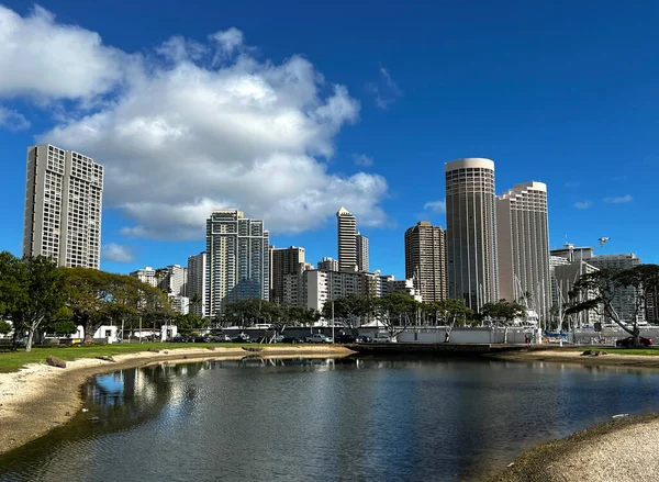 View of the Honolulu Skyline from Magic Island with the Kahanamaku Lagoon and Ala Wai Boat Harbor in the foreground.