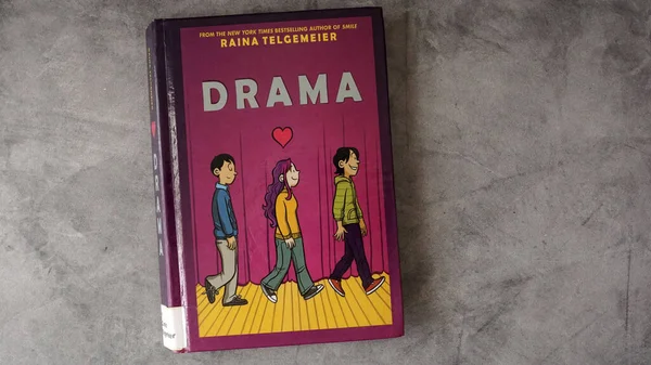 stock image A copy of Raina Telgemeier's graphic novel, Drama. The book has landed on many banned book lists at schools and libraries.