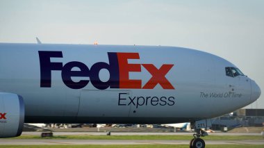 Chicago, IL, USA - July 18 2023: FedEx cargo plane taxies on the runway after landing at Chicago O'Hare International Airport.   clipart