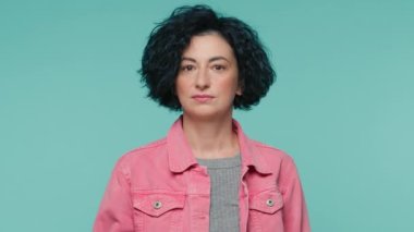 Ciddi 40 'lı yaşlarda olgun bir kadın elini sıkar ve hayır der. Mavi stüdyo arka planında günlük giysiler içinde poz verir. Olgun kadın modeli bir şeyi sevmez, kötü seçim hareketi, yasaklama