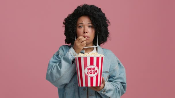 안경을 곱슬머리의 여자가 팝콘을 수없게 먹으면서 다큐멘터리 영화를 아프리카 미국인 — 비디오