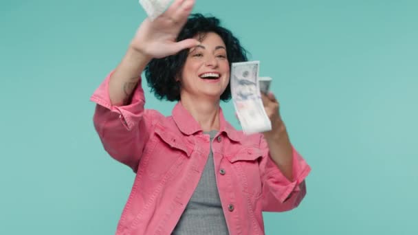 Wasteful Mature Woman 40S Pink Jacket Scattering Dollars Looking Happy — Stock Video