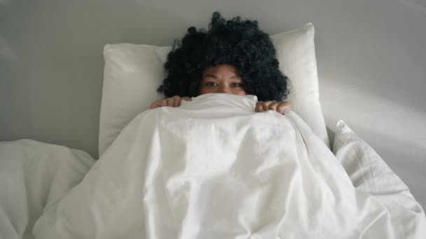 Mutlu Afro Amerikan Kadın Yatakta Battaniyesinden Dışarı Bakıyor Kameraya Gülümsüyor — Stok video