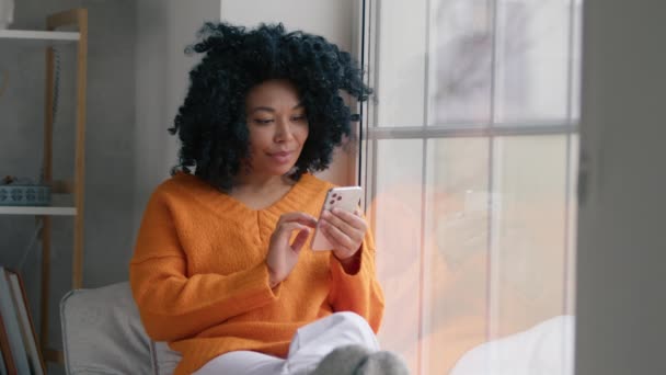 Portrait Relaxed Black Woman Holding Smartphone Watching Social Media Sitting — Stock Video