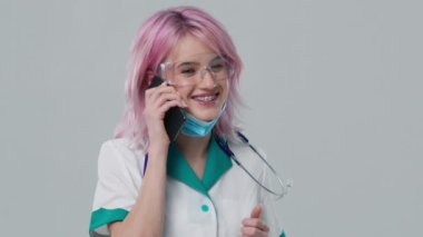 Profesyonel bir tıp çalışanı müşterisiyle iş yerindeki cep telefonuyla kolay ve uygun teletıp uygulaması ve ezici telefon kullanarak konuşur. Nitelikli terapist doktordan sanal konsültasyon