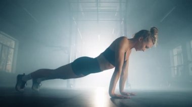 Close-up shot of a woman performing challenging workout for upper body muscles. Female athlete in the standard push-up position for building chest strength. High quality 4k footage