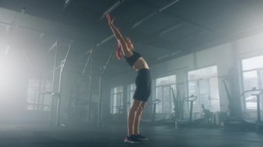 Woman supporting the body in a stable, inverted vertical position. Female athlete performing a handstand with straight arms. High quality 4k footage