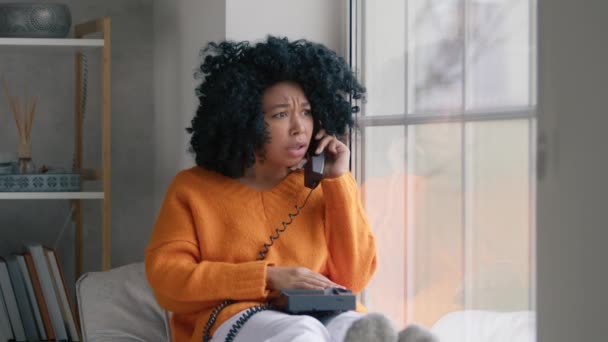 Portrait African American Woman Orange Sweater Sitting Window Handset Phone — Stock video