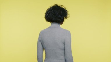 Rear view of mature woman turning back and looking from head to toe with neglect and disregard. Bored face expression of neglect adult woman saying who are you and what are you doing here slow motion