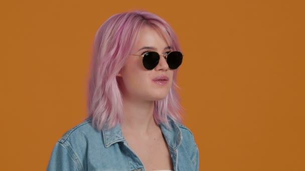 Close Girl Wearing Denim Jacket Chewing Bubble Gum Orange Screen — Vídeo de Stock