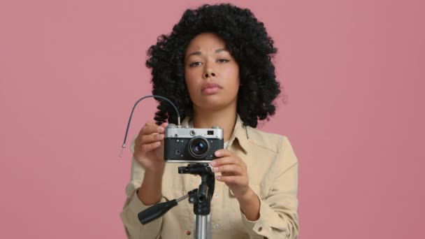 Serious Female Photographer Capturing Pictures Film Camera Mount Tripod Pink — Vídeo de Stock