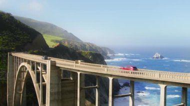 Cinematic view of cars driving by world famous Bixby bridge, 4K still footage shot on RED camera. Road trip concept, copy space for scenic travel and West Coast tourism on vacation in California USA