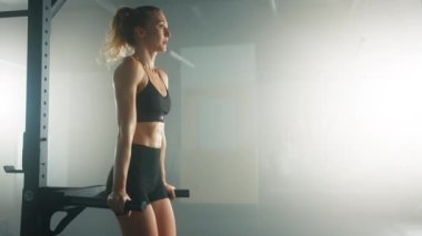 Caucasian female athlete developing full-body strength and fitness. Close-up shot of blonde-haired woman strengthening her shoulders and upper back. High quality 4k footage