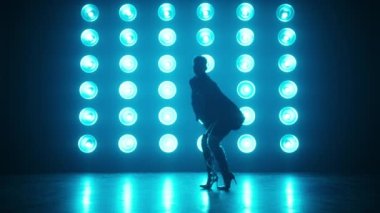 Profesyonel Kadın Dansçı Silueti Mavi Ampulün Önünde Modern Dans Rolünü sahneleyen Karanlık Stüdyo Ortamı Sanal Prodüksiyonunda Büyük Ekran, RED kamerada 4K görüntü
