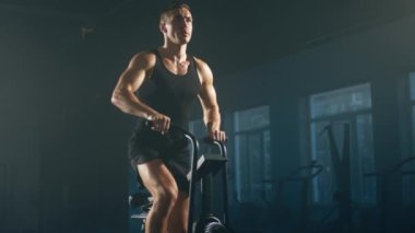 Close-up view of male athlete in black sportswear burning a lot of calories. Portrait of dedicated, active man boosting his cardio capacity on elliptical trainer. High quality 4k footage