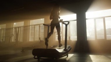 Unrecognized female athlete during her fitness and cardio routine. Back view of healthy woman jogging and sprinting for building slim and muscular legs. High quality 4k footage