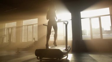 Back view of healthy woman jogging and sprinting for building slim and muscular legs. Female athlete performing high intensity cardiovascular training. High quality 4k footage