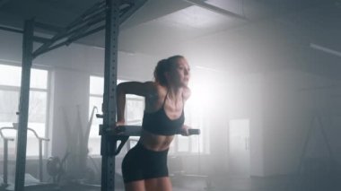 Portrait of blonde sportswoman in training her triceps. Close-up view of caucasian woman practicing strength training to build toned and strong muscles. High quality 4k footage