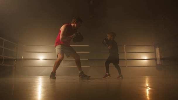Close Sporty Boy Punching Leather Gloves Train His Endurance Little — Vídeo de Stock
