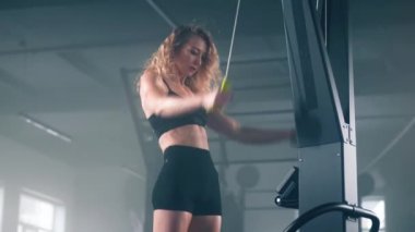 High-intensity workout of a skilled female with toned body muscles. Portrait of a beautiful woman gaining lean arm biceps to improve her health. High quality 4k footage