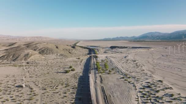Trade Train Crossing Modern Wind Farm Beautiful Mountains Desert Landscape — Stock video