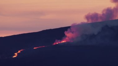 Breathtaking epic view of red hot molten lava river flowing from fissure on Hawaii Mauna Loa volcano eruption. Cinematic shot on RED camera at pink sunset. Scenic view glowing red hot lava river flow