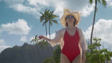 Hawaii yaz gezisinde mutlu bir kadın. Yaz tatili yeni anılar seyahat konsepti. Gezgin ya da gezgin blogcu güzel tropikal plajlar, orman dağı vadisi sinematik arka planından geçer.