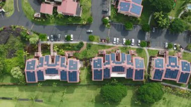 Alternatif elektrik. Enerji üretimi için yenilenebilir kaynakların kullanımı. Yeşil, güneşli Hawaii Adası ABD 'deki yerleşim yerlerinin çatılarındaki güneş panelleri. 4K Büyük Ada Oteli