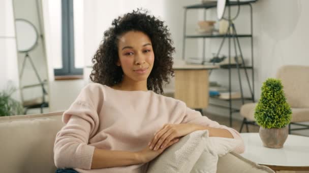Smiling Beautiful African American Woman Looking Camera Sitting Sofa Alone — Stock Video