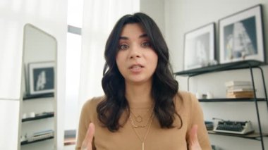 Webcam görüntüsü 4K. Pozitif Latin Amerikalı iş kadını iş yerinde video konferansında kameraya konuşuyor. Finansal danışman yönetici danışmanlık istemcisi, merkez ofiste kameraya bakıyor.