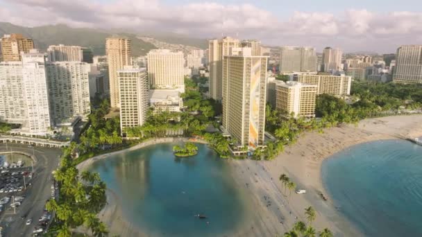 水中でのシネマティックな空中近代的な街並みドローンビュー 青い空と晴れた夏の夕日のワイキキビーチ 観光と旅行のビジネス4K映像 ハワイの休暇の撮影 近代的なリゾート — ストック動画